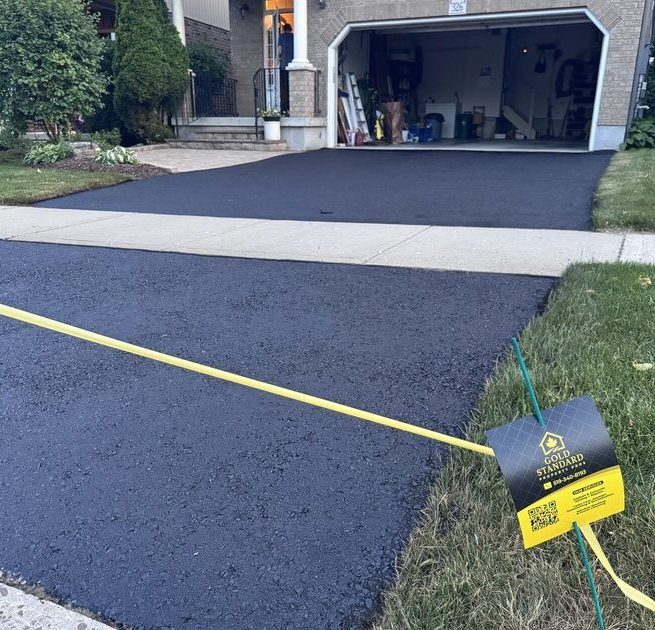 Freshly sealed matte-black driveway in Kitchener-Waterloo